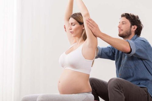 Ciężarna kobieta wykonuje ćwiczenia oddechowe